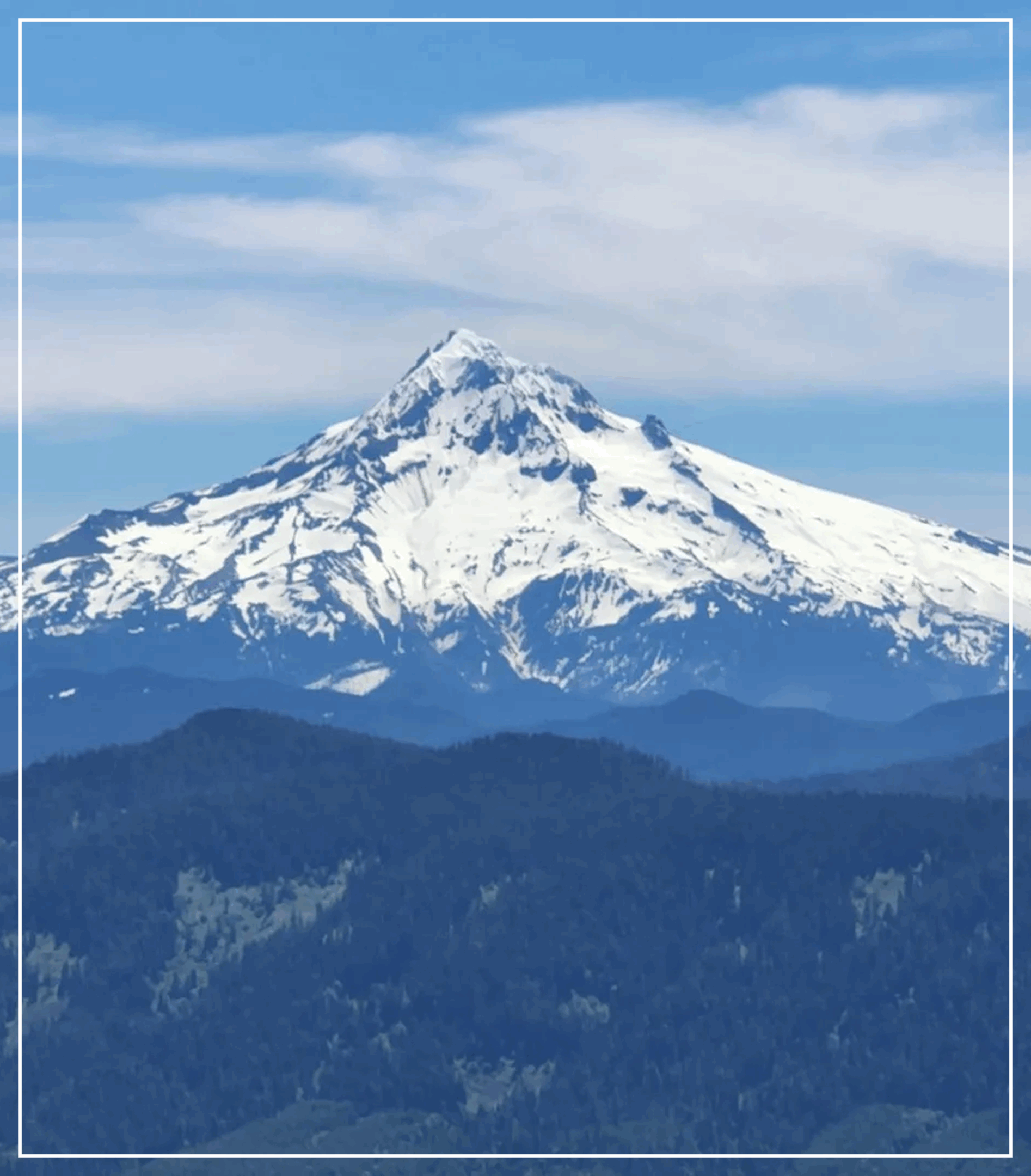 Snow-covered mountain peak under a blue sky.